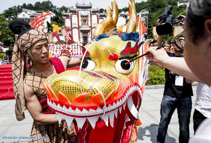 Un hombre dibuja el ojo de una marioneta de dragón durante una feria cultural para marcar el próximo Festival del Bote del Dragón, en el condado Zigui, capital de la provincia central de Hubei, China, el 8 de junio de 2016. El Festival del Bote de Dragón o "Duanwu" en chino, se celebra el quinto día del quinto mes del calendario lunar, celebrándose este a?o el 9 de junio. (Xinhua/Xiao Yijiu)