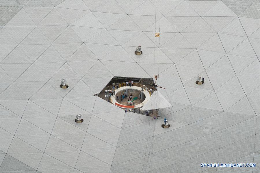 El último panel triangular del reflector del Telescopio de Apertura Esférica de 500 metros, o "FAST", es colocado en el condado de Pingtang, provincia de Guizhou, en el suroeste de China, el 3 de julio de 2016. La instalación del "FAST", el radiotelescopio más grande del mundo, fue completada el domingo por la ma?ana al colocar el último de los 4,4450 paneles en el centro del gran plato. Los científicos comenzarán las pruebas de depuración y observación del FAST. (Xinhua/Liu Xu)