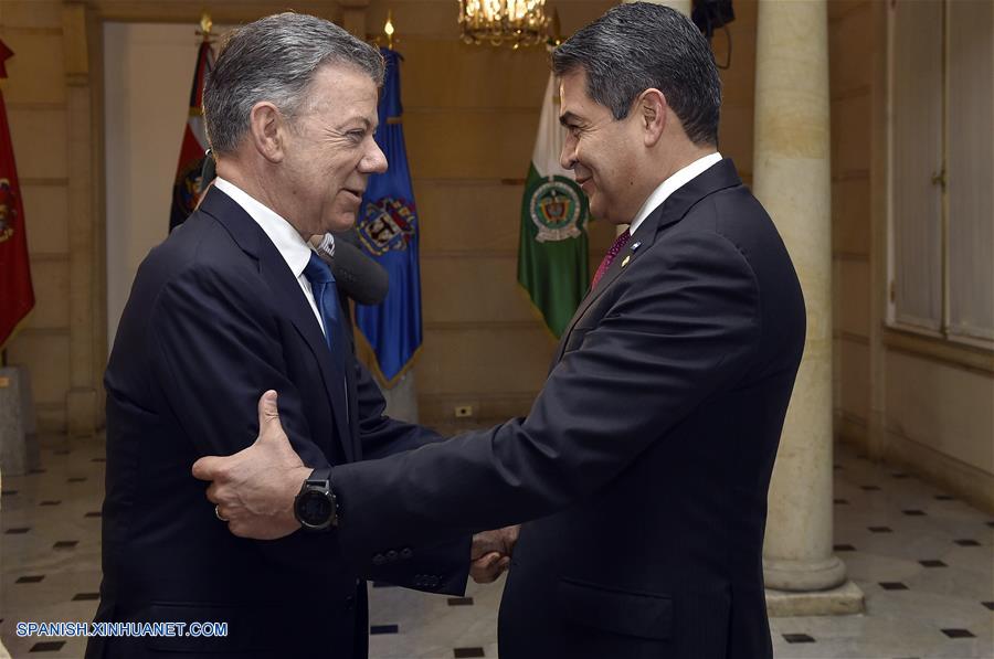 BOGOTA, agosto 6, 2018 (Xinhua) -- Imagen cedida por la Presidencia de Colombia, del presidente colombiano, Juan Manuel Santos (i), recibiendo a su homólogo de Honduras, Juan Orlando Hernández (d), previo a la cena en honor a los jefes de Estado y de Gobierno que participarán en la ceremonia de posesión presidencial, en Bogotá, capital de Colombia, el 6 de agosto de 2018. De acuerdo con información de la prensa local, Santos dejará el martes la Presidencia colombiana después de ocho a?os de mandato, e Iván Duque tomará posesión del cargo. (Xinhua/Efraín Herrera/Presidencia de Colombia)