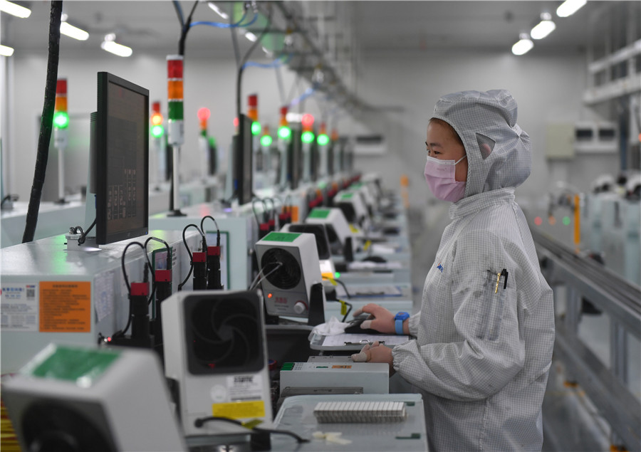 Una empleada de una compa?ía de tecnología optoelectrónica reanuda su trabajo en Nanchang, provincia de Jiangxi, 24 de febrero del 2020. [Foto: Xinhua]