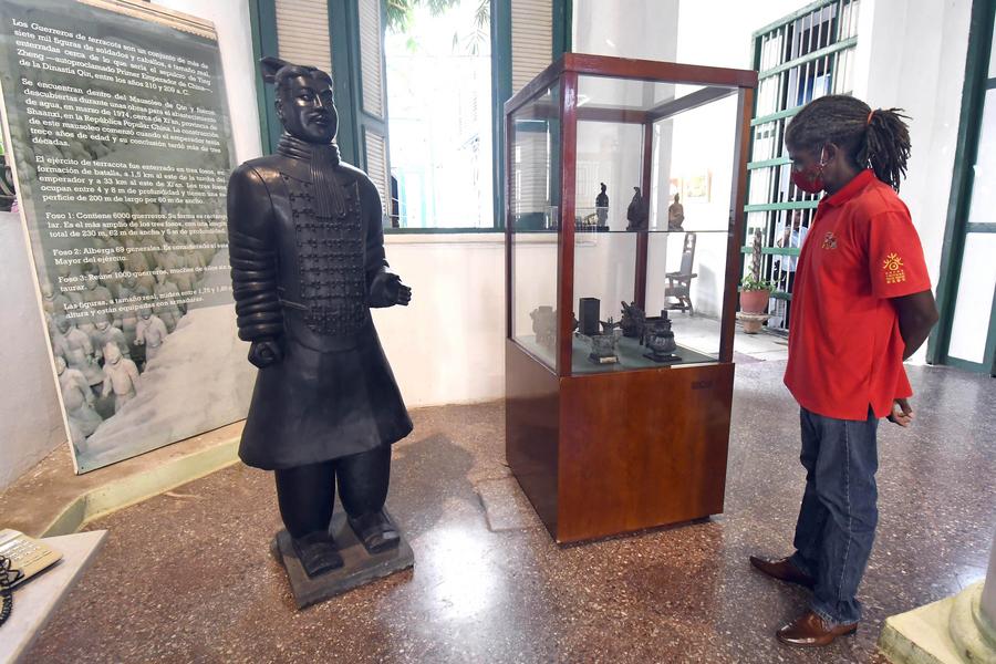 Imagen del 28 de septiembre de 2021 de un hombre observando objetos exhibidos durante la exposición "Presencia", un homenaje a los chinos que se asentaron en la isla, en la Casa de Artes y Tradiciones Chinas, en La Habana, capital de Cuba. (XinhuaJoaquín Hernández) 