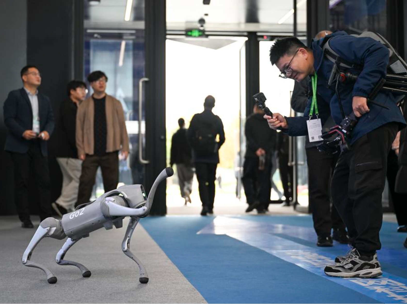 Un visitante interactúa con un perro robótico inteligente en la Exposición Luz de la Internet, en Wuzhen, provincia de Zhejiang, en el este de China, el 19 de noviembre de 2024. (Xinhua/Cai Xiangxin)