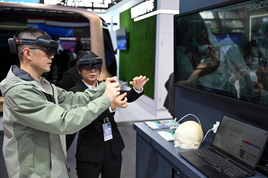 Un visitante prueba un sistema de imagen médica inteligente holográfico bajo la guía de una asistente en la exposición "La luz de la Internet", en Wuzhen, ciudad de la provincia oriental china de Zhejiang, el 19 de noviembre de 2024. (Xinhua/Cai Xiangxin)